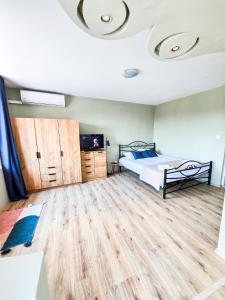 a bedroom with a bed and a wooden floor at Guest House Medusa - Old town in Pomorie +86 photos