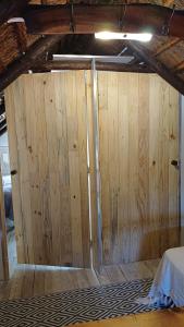 a wooden door in the middle of a room at The Coach House Bredasdorp in Bredasdorp