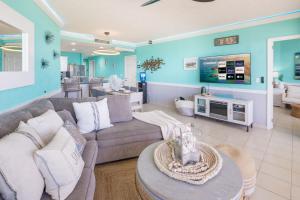a living room with a couch and a tv at Sonoran Spa Amazing Oceanfront E206 in Puerto Peñasco