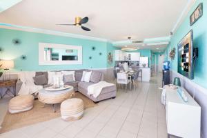 a living room with a couch and a table at Sonoran Spa Amazing Oceanfront E206 in Puerto Peñasco +38 photos