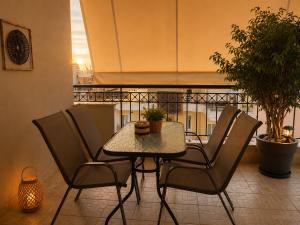 a table and chairs in a room with a balcony at Leas House in Preveza