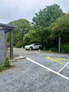 a car parked in a parking lot next to a building at Lily's Place in Wexford