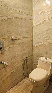 a bathroom with a toilet and a shower at Ira Wanderlust Homes & Tours in Trichūr