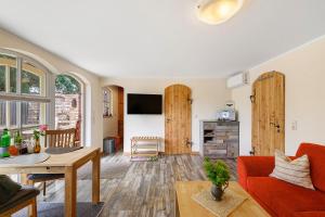 a living room with a red couch and a table at Ferienhaus Reiseoase in Bützow