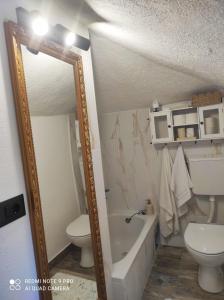 a bathroom with a mirror and a tub and a toilet at House Silvana in Postira +24 photos