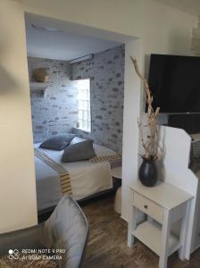 a bedroom with a bed and a tv and a chair at House Silvana in Postira