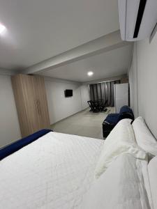 a bedroom with a large white bed in a room at Catamarã Pé na Areia in Angra dos Reis