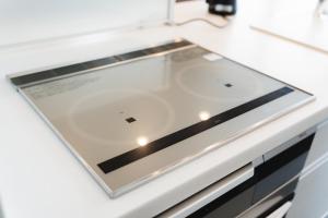 a glass counter top in a white kitchen at SANMI Hayama in Hayama +74 photos