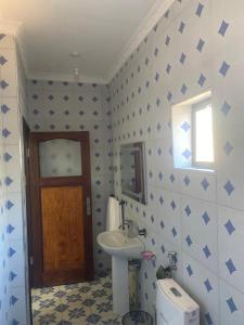 a bathroom with a sink and a mirror and a toilet at Summerland Lodge in Chembe