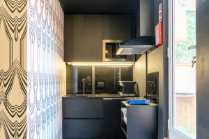 a kitchen with a sink and a counter top at Dejavu Terrace Setúbal in Setúbal