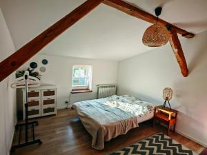 a bedroom with a bed in a attic at Wczasy z Wędką in Gardna Wielka
