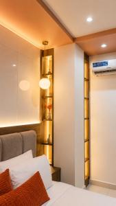 a bedroom with a bed and a wall with shelves at The Luxe Cottage in Ikeja +9 photos
