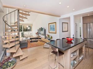 a kitchen and living room with a spiral staircase at Lionshead Center in Vail
