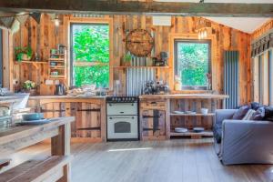 a kitchen with wooden walls and wooden floors at 1 Bed in Bream oc-m43316 in Bream