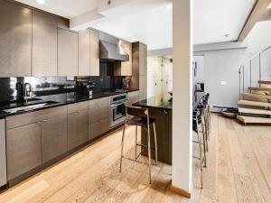 a kitchen with stainless steel appliances and wooden cabinets at Lionshead Center in Vail