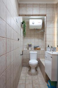 a bathroom with a toilet and a sink at liofito village house in Pemónia +29 photos