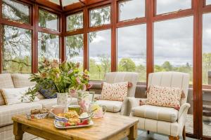 a living room with a table and chairs and windows at 3 Bed in Lintrathen oc-w42585 in Bridgend of Lintrathen