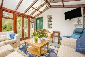 a living room with a couch and a table at 3 Bed in Lintrathen oc-w42585 in Bridgend of Lintrathen