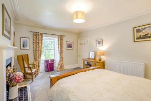 a bedroom with a bed and a desk and a window at 3 Bed in Lintrathen oc-w42585 in Bridgend of Lintrathen