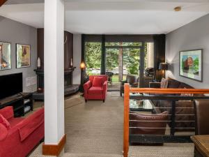 a living room with a red couch and a red chair at Ptarmigan Townhome 2 in Vail