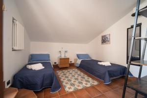 a room with two beds and a ladder at Breathtaking Sea Views & Jacuzzi in Cefalù in Cefalù