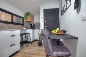 a kitchen with a table with a bowl of fruit on it at דיאמנט - Diamond in Safed +9 photos