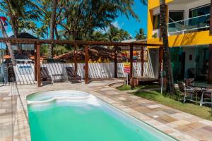 a swimming pool in the backyard of a house at Pousada La Bella Luna in Porto De Galinhas +49 photos