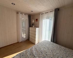 a bedroom with a bed and a window at Dimantu nami in Upesgrīva