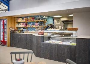 a restaurant with a counter with food on display at The Pointon-Bordeaux Caravan Co in Rhyl