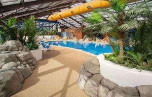 a pool in a resort with a large inflatable slide at The Pointon-Bordeaux Caravan Co in Rhyl