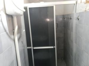 a shower with a glass door in a bathroom at Pousada Mais E Vida 24h in Teresina