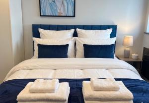 a bedroom with a large bed with two towels on it at Spacious one bedroom flat- super fast Wifi - slp4 -SHIP02 in Brighton & Hove