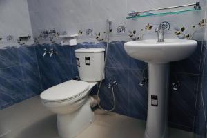 a bathroom with a toilet and a sink at Hotel Comfort Inn Sylhet in Sylhet