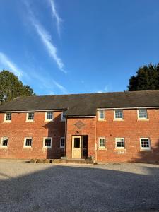 a large red brick building with a door on it at Castell Cottages Central with Parking in Caerphilly