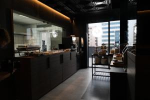 a kitchen with a counter and a table in it at Hotel PALAZZO PEPE & JACUZZI in Naples