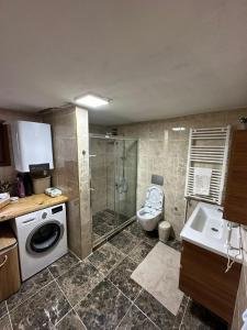 a bathroom with a washing machine and a toilet at TRIA APART OTEL in Uzungöl +53 photos