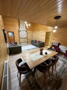 a living room with a table and a couch at TRIA APART OTEL in Uzungöl