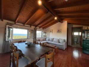 a living room with a table and a couch at Stavroula's House in Argyrádes +19 photos