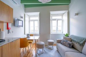 a living room with a couch and a table at Figueirinhas Home Green in Coimbra