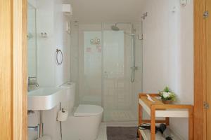 a bathroom with a shower and a toilet and a sink at Figueirinhas Home Green in Coimbra