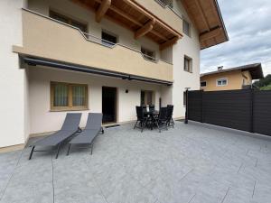 a patio with chairs and a table and a fence at Mountain hOMES in Axams +32 photos