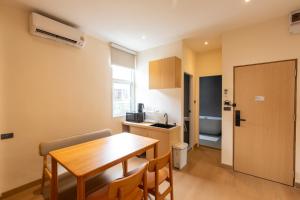 a kitchen and dining room with a table and chairs at Acoz in Ban Zong Katiam