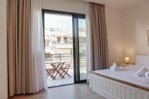 a bedroom with a bed and a balcony with a table at Urban Liv Athens in Athens +99 photos