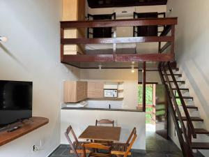 a kitchen and dining room with a spiral staircase at Hotel da Ilha in Ilhabela