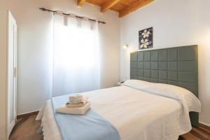 a bedroom with a bed with two towels on it at Blue Río Playa, Casa & Studio in Costa Calma +126 photos