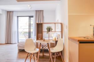 a kitchen and living room with a table and chairs at Urban Liv Athens in Athens