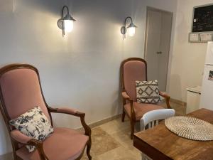 a living room with two chairs and a table at Giovanna in Marseillan