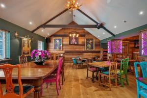 a dining room with wooden tables and colorful chairs at The Hideaway - Tranquil Glamping Pod in Narberth