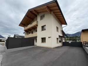 a large white house with a black fence at Mountain hOMES in Axams