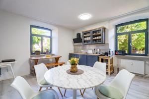 a kitchen and dining room with a table and chairs at Pfarrgarten in Kippenheim
